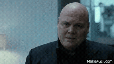 Bald Man In Black Suit Looking Serious GIF
