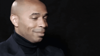 Bald Man In Black Turtleneck And Suit GIF