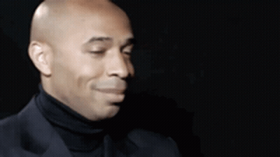 Bald Man In Black Turtleneck And Suit GIF