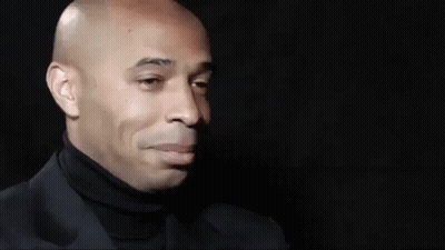 Bald Man In Black Turtleneck And Suit Smiling GIF