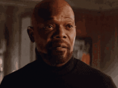 Bald Man In Black Turtleneck Looking At Camera GIF