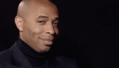 Bald Man In Black Turtleneck Looking Sideways GIF