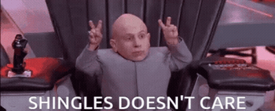 Bald Man In Chair With Hands Up Shingles Doesn't Care GIF