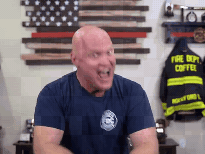 Bald Man In Fire Department Shirt Making Funny Face GIF