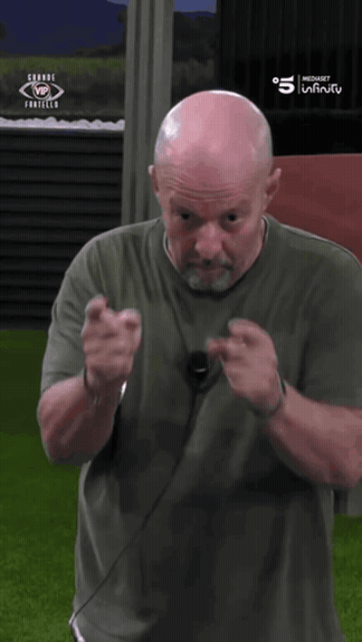 Bald Man In Front Of Grande Fortello Sign GIF