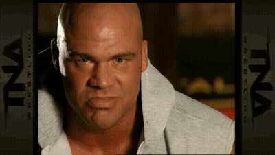 Bald Man In Front Of Ina Wrestling Ad GIF