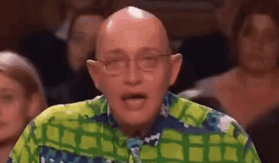 Bald Man In Glasses And Colorful Shirt Facing Crowd GIF
