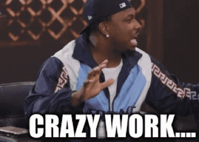 Bald Man In Glasses And Gray Sweater Saying Wow By Window GIF