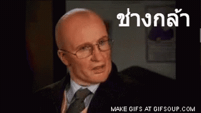 Bald Man In Glasses And Suit Speaking Foreign Language GIF