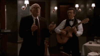 Bald Man In Glasses And Suit With Arms Outstretched GIF