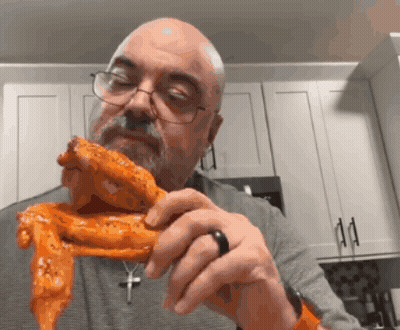 Bald Man In Glasses Holding Chicken Wing GIF