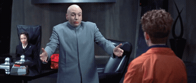 Bald Man In Gray Coat Talks To Man In Orange Jacket GIF