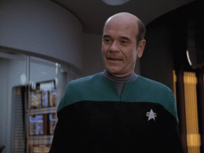 Bald Man In Green And Black Uniform With Star GIF