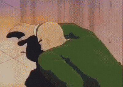 Bald Man In Green Jacket Kneeling GIF