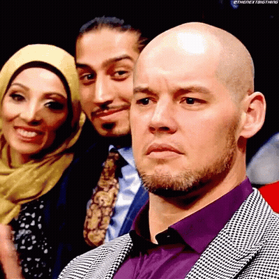 Bald Man In Purple Shirt In Front Of Group GIF