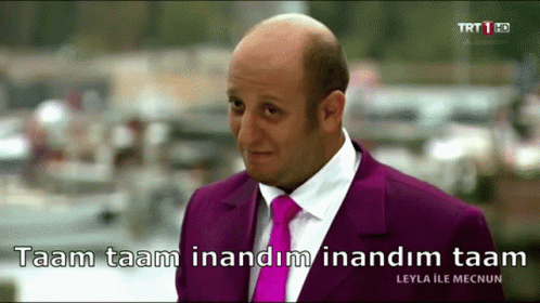 Bald Man In Purple Suit Saying Taam Taam GIF