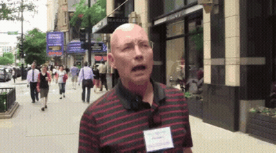 Bald Man In Red And Black Striped Shirt In Front Of Marlow Store GIF