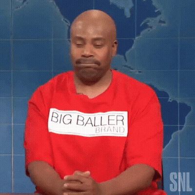 Bald Man In Red Big Baller Brand Shirt Sitting With Hands Folded GIF