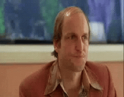 Bald Man In Red Jacket Sitting At Table GIF