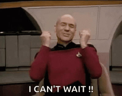 Bald Man In Red Sweater Holding Fists In Air GIF