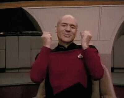 Bald Man In Red Sweater Sitting With Arms In Air GIF