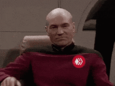 Bald Man In Red Sweater With Diamond Emblem GIF