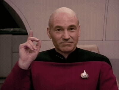 Bald Man In Red Uniform With Star Trek Badge GIF