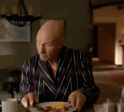 Bald Man In Robe Looking At Phone Saying Holy Fucking GIF