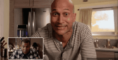 Bald Man In Striped Shirt Looking At Another Bald Man GIF