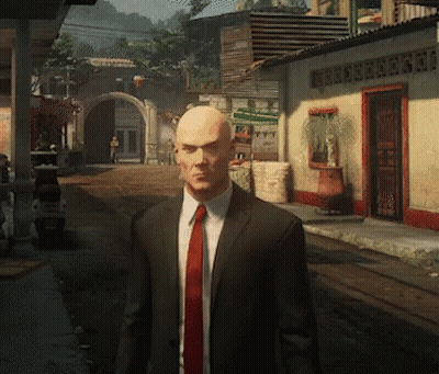 Bald Man In Suit And Red Tie Standing In Street GIF
