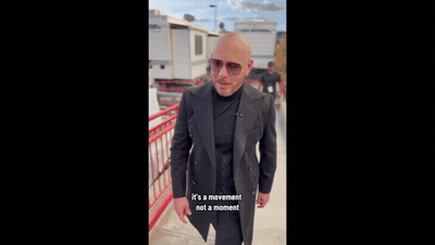 Bald Man In Suit And Sunglasses By Railing GIF