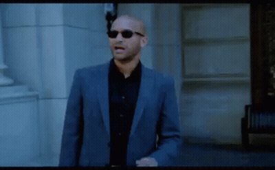 Bald Man In Suit And Sunglasses Walking GIF