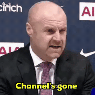 Bald Man In Suit And Tie At Mic GIF