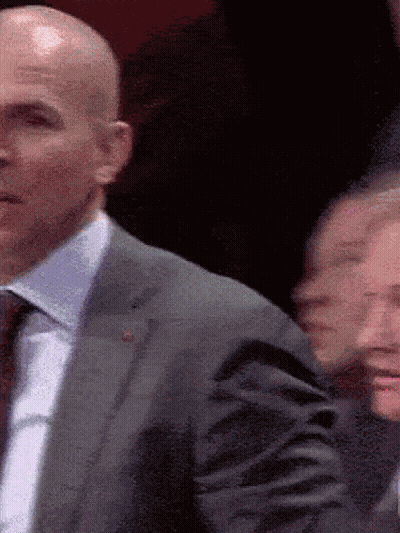 Bald Man In Suit And Tie In Crowd GIF