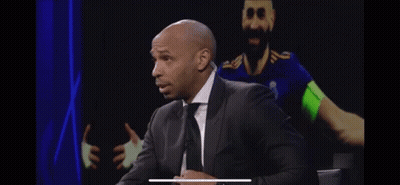 Bald Man In Suit And Tie In Front Of Soccer Player GIF