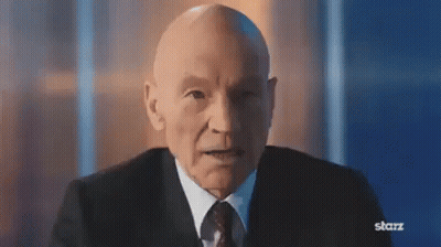 Bald Man In Suit And Tie Looking At Camera GIF