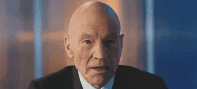 Bald Man In Suit And Tie Looking At Camera GIF