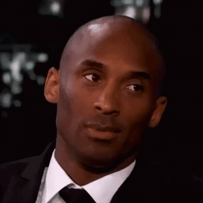 Bald Man In Suit And Tie Looking At Camera GIF