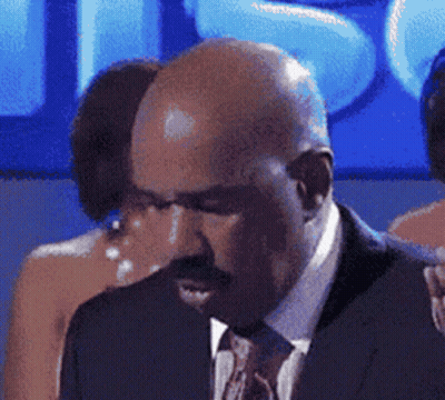 Bald Man In Suit And Tie Looking Down GIF