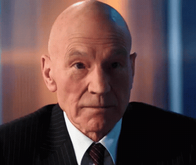 Bald Man In Suit And Tie Looking To Side GIF