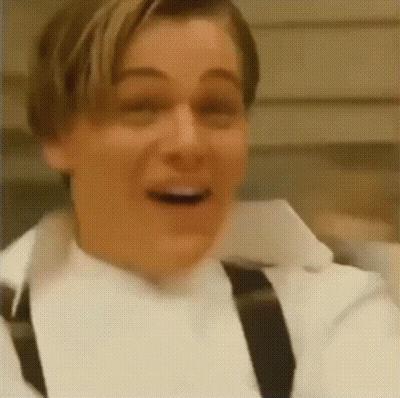 Bald Man In Suit And Tie Making Funny Face On Stage GIF