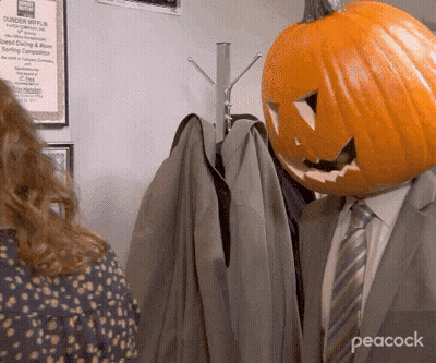 Bald Man In Suit And Tie Sitting In Chair GIF