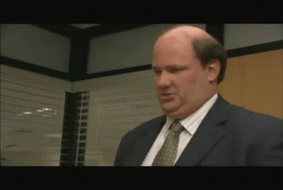 Bald Man In Suit And Tie Talking In Office GIF