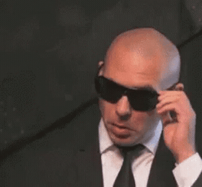 Bald Man In Suit And Tie Wearing Sunglasses GIF