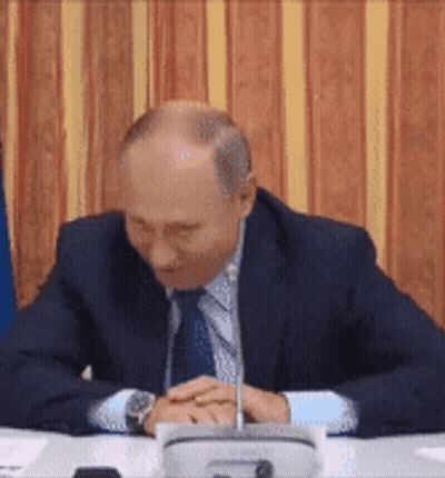 Bald Man In Suit And Tie With Folded Hands GIF