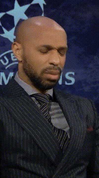 Bald Man In Suit In Front Of UEFA Logo GIF