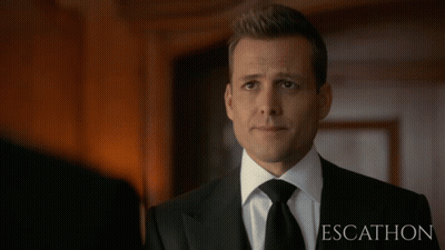Bald Man In Suit Looking Down GIF