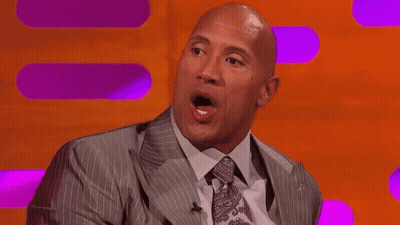 Bald Man In Suit Making Funny Face On Stage GIF