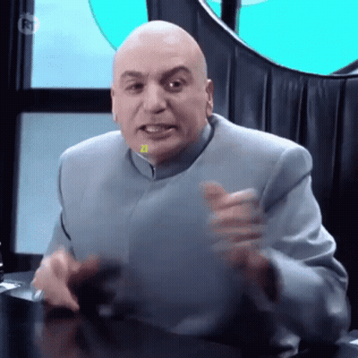 Bald Man In Suit Sitting With Hands Outstretched GIF