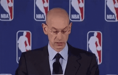 Bald Man In Suit Smiling At Microphone GIF
